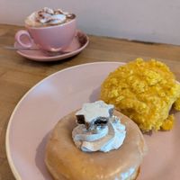 Hot chocolate in the background. Zimtstern and Orange donut in the foreground. at Brammibal's Donuts - Prenzlauer Berg in Berlin