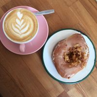Maple smoked coconut donut and cappuccino  at Brammibal's Donuts - Prenzlauer Berg in Berlin