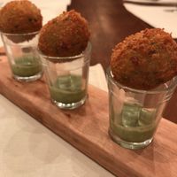 “Pérola da Yby” - Fried manioc balls filled with corn purée and served with herbal cream at Piccoli Cucina in Sao Paulo