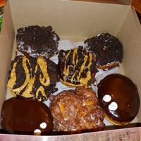 Dirt (cookies and cream), ODB (cookies with peanut butter drizzle), Portland Creme (like a boston creme) and apple fritter. at Universal Studios - Voodoo Doughnut in Orlando