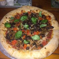 Vegan pizza with cheese, mushrooms, olives, tomato, meat replacement and basil at Bagby Beer Company in Oceanside