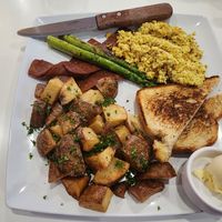 What Happens in Vegas: tofu scramble, breakfast potatoes, vegan bacon, sourdough toast, asparagus (ordered September 2023). They were out of vegan sausage. at The Modern Vegan in Las Vegas