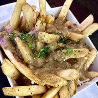 CANADIAN POUTINE
French fries topped with shredded mozzarella and cheddar cheese, smothered in our homemade sausage and mushroom gravy.  at The Modern Vegan in Las Vegas