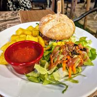 Hamburguesa Vegana con Patatas Bravas y Ensalada at Canadu in Malaga