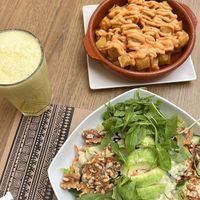 papas brava and green salad with avocado and walnuts   at Canadu in Malaga