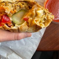 Tempeh Wrap with side of chili sauce. Not as much tempeh in most bites as it appears in this picture, but still Very good. at Edgy Veggy in Sofia