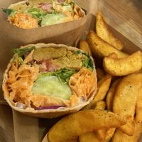 Unchicken burrito with salad and potato wedges  at Edgy Veggy in Sofia