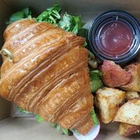 Avocado toast croissant with vegan feta, vegan egg yolk, radishes and arugula at L'Artisane Creative Bakery in Coral Gables