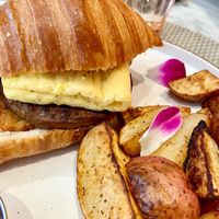 VTE croissant with hash brown, sausage patty, just egg and bacon at L'Artisane Creative Bakery in Coral Gables