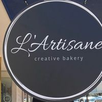 The sign outside at L'Artisane Creative Bakery in Coral Gables