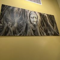 Gorgeous enlarged photos throughout this exquisitely authentic space. Wat Mahathat Buddha head ensconced in massive tree roots, perhaps due to a temple’s abandonment.  at Blue Orchid in Jacksonville