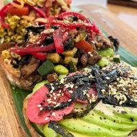Trio Avo-avocado toast platter with three unique flavors: Japanese Wasabi, Indian Tofu Scramble, and Mediterranean Hummus at Dharma Coffee & Juice in Ubud