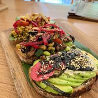 Trio Avo-avocado toast platter with three unique flavors: Japanese Wasabi, Indian Tofu Scramble, and Mediterranean Hummus at Dharma Coffee & Juice in Ubud