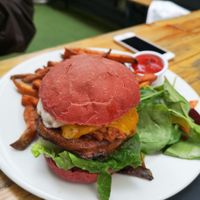 Vegan BBQ burger with beetroot bun and sweet potato fries at The Rose in South East London