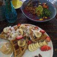 Half eaten vegan breakfast bowl (sorry was too good to be patient), and vegan waffles 🤤  at Vida Surf Shop Cafe in Bondi Beach