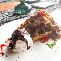 Strawberry and Cream Waffles - With strawberry jam, sliced strawberry, cookie crumble ice cream and coconut sprinkle at Zest Ubud in Ubud