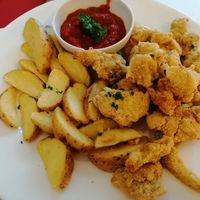 Fried seitan in cornjackets with steak potatoes and spicy sauce at Veganeria in Budapest