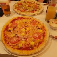 4 cheese pizza and tofu and garlic pizza in the background at Veganeria in Budapest