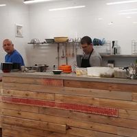 This are the owners,kitchen is in the open space of the restaurant. You can see how the food is made at Humus Bala in Rakefet