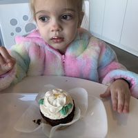 Happy toddler with her vegan cupcake  at Carina's Bakery in Beaverton