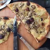 Pizza with thin potato slices, champignon, fresh rosemary, vegan cheese, olives at Café Piccolina in Aarhus