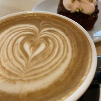 Oat latte & choc, rose & pistachio cake (vegan)! at South Street Kitchen in Sheffield