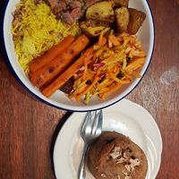 Lentil rice, lentil dal, roast carrot/potatoes and carrot/apple slaw, with a pear/blueberry cake on the side. at Big Fig in Wanaka