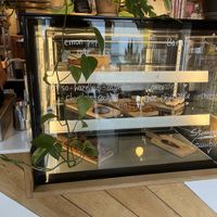 Pastry display, vegan sweets are clearly labeled  at Karibu Cafe in Utrecht