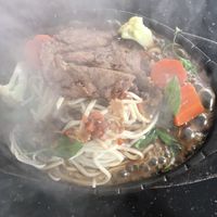 Mock pork chop with noodles on a sizzling plate (menu calls it vegetable chop noodle teppanyaki). Requested no egg to make it vegan.  at Monorom Garden in Battambang
