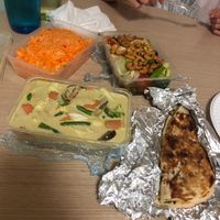 Green curry, saffron coconut rice, stir fry, and garlic naan bread. at Green Chillies in Darwin