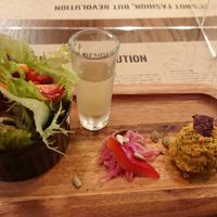 Starter for lunch course: salad, health drink shot, pickled vegetables and hummus at Premarché Alternative Diner in Kyoto
