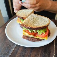 FERMENTO BAGEL (V)
$14.00
frittata with onion, potato, spinach and tomato inside

topped with melted mozzarella , tomato, AVOCADO on sourdough (they were out of bagels) at Fermento in Long Beach