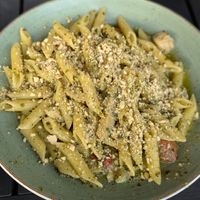 Plant-based penne pollo pesto. The leftovers were so oily that it quickly soaked through the takeout container, the bag and got oil on my partner's pants. at Il Fornello - Danforth Ave in Toronto