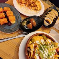 Vegetarian nachos, fried brie cheese, vegan patatas brabas, vegan veggie gyozas, vegetarian mushroom cream croquettes   at Kino in Barcelona