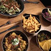 Caesar salad, mac n cheese, chips, chili bowl, slaw at Rudy's Dirty Vegan Diner in North West London
