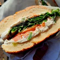 Onion bagel with veggie tofu spread, lettuce, and tomato at Tompkins Square Bagels in New York City