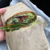 Beet wrap with veggies and tofu, wrapped in paper   at Roots Juice Bar - Churn Creek in Redding