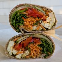 sprouted grain wrap with grilled tofu, red cabbage, cucumber, bell pepper, carrot, spinach, and pesto sauce at Roots Juice Bar - Churn Creek in Redding