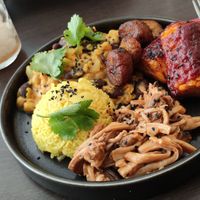 Bowl of Curry of coral lentils, chickpeas and red beans, turmeric rice, banana plantins, eryngii spicy cajun sauce at Annie's Kitchen in Lille