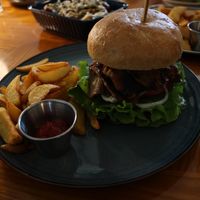 Bulgogi burger with a side of small potato wedges  at And 유 (Yu) Cafe in Jeju