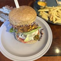Vegan “chicken” burger served with wedges and vegan “cheddar” dip 🌱🍔 Hamburger buns are from the local bakery called RnR.  at And 유 (Yu) Cafe in Jeju