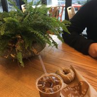 Orange blossom donut, cold brew with oat milk, and ambience. at Mighty-O Donuts - Denny Triangle in Seattle