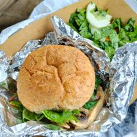 Vegan grilled veggie sandwich with peppers, mushrooms, and spinach; with heirloom tomato side salad. at Souls Ground Cafe in Benton Harbor