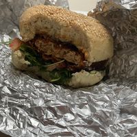 Vegan burger "Veganski pohancek" with wheat flour based bombette with pumpkin oil and pumpkin seeds, fried tofu, tomato, arugula, vegan mayo.  at Bullizza in Ljubljana