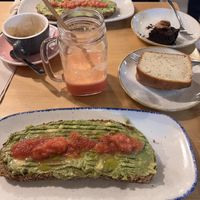 Avocado toast, lemon and brownie sweets, fresh smoothie  at Maiatza in San Sebastian