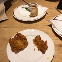 Half eaten onion bhajis and vegetable Somoza  at Nataraj - Harajuku Omotesando in Tokyo
