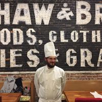 Chef Max fuzzily standing in front of the 1895 original advertisement in Damfino's, discovered when the wall was taken down during renovations.  at Damfino's in Quincy