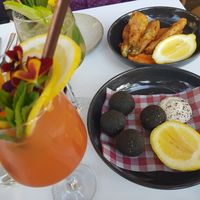 Black arancini with brown mushroom, vegan Parmigiani and cashew aioli plus zucchini flowers with soy ricotta at Mark & Vinny's Spaghetti & Spritz in Surry Hills