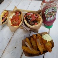 Three servings: the red, yellow and kebab dishes, and french fries. at Cookoomela Grill in Athens