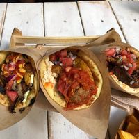 Yellow, red and kebab pitas, and potatoes at Cookoomela Grill in Athens